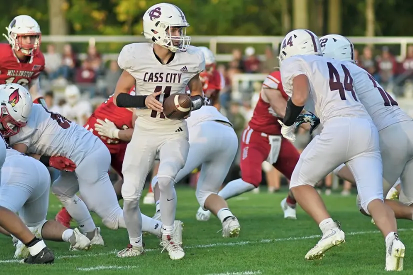 Cass City quarterback Preston Dorland (11) prepares to hand off to one of his backs during his team's 17-14 overtime win over Millington during week 4.